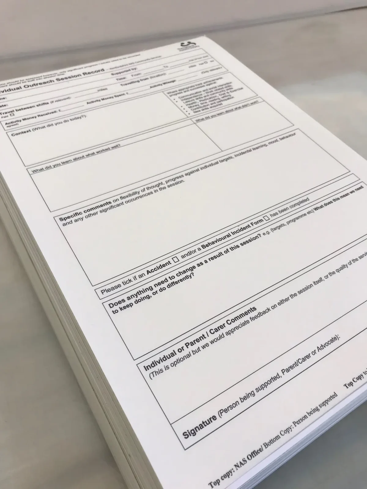 Individual outreach session record form on desk