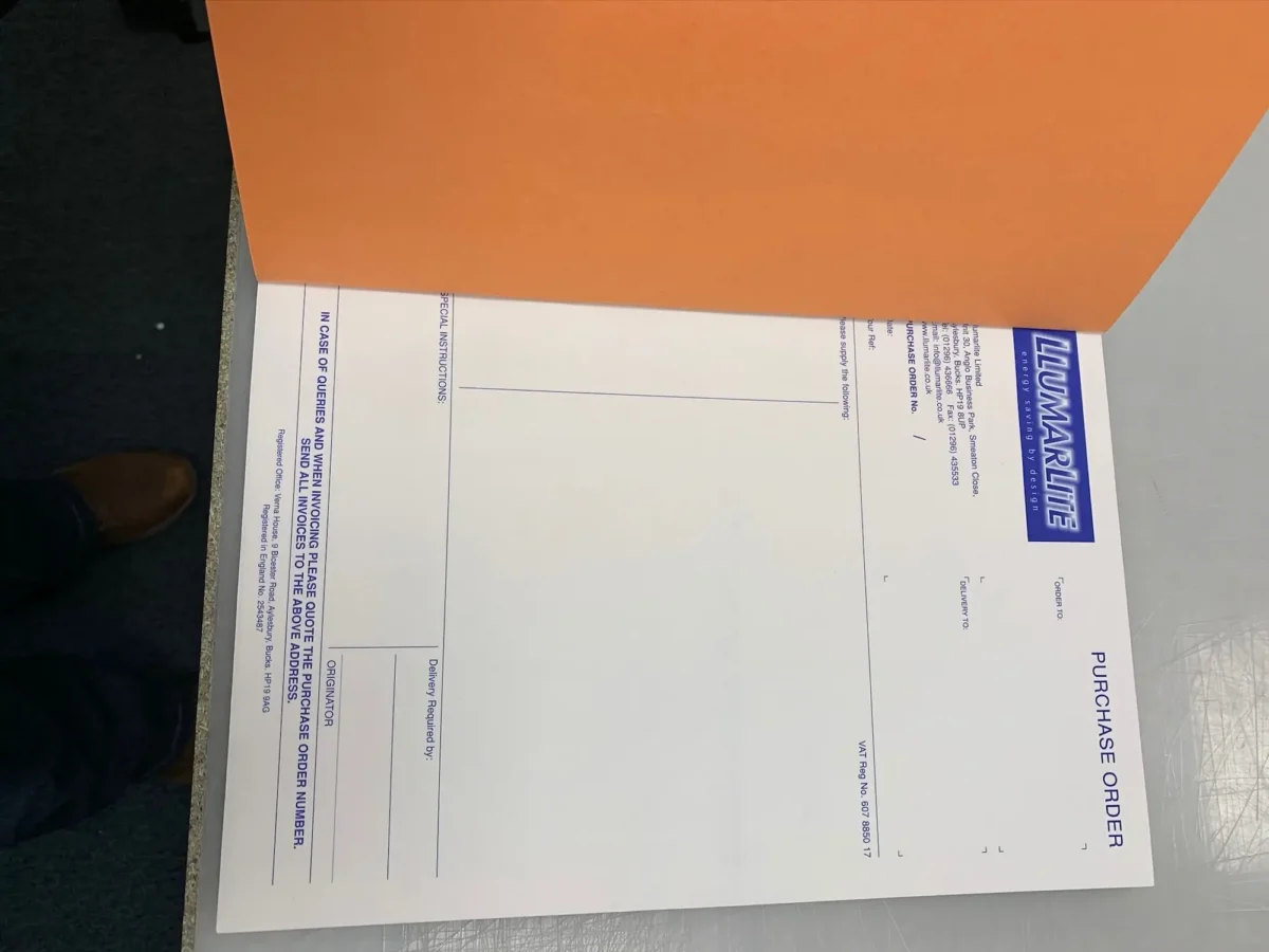 Llumarlite purchase order form partially covered by folder