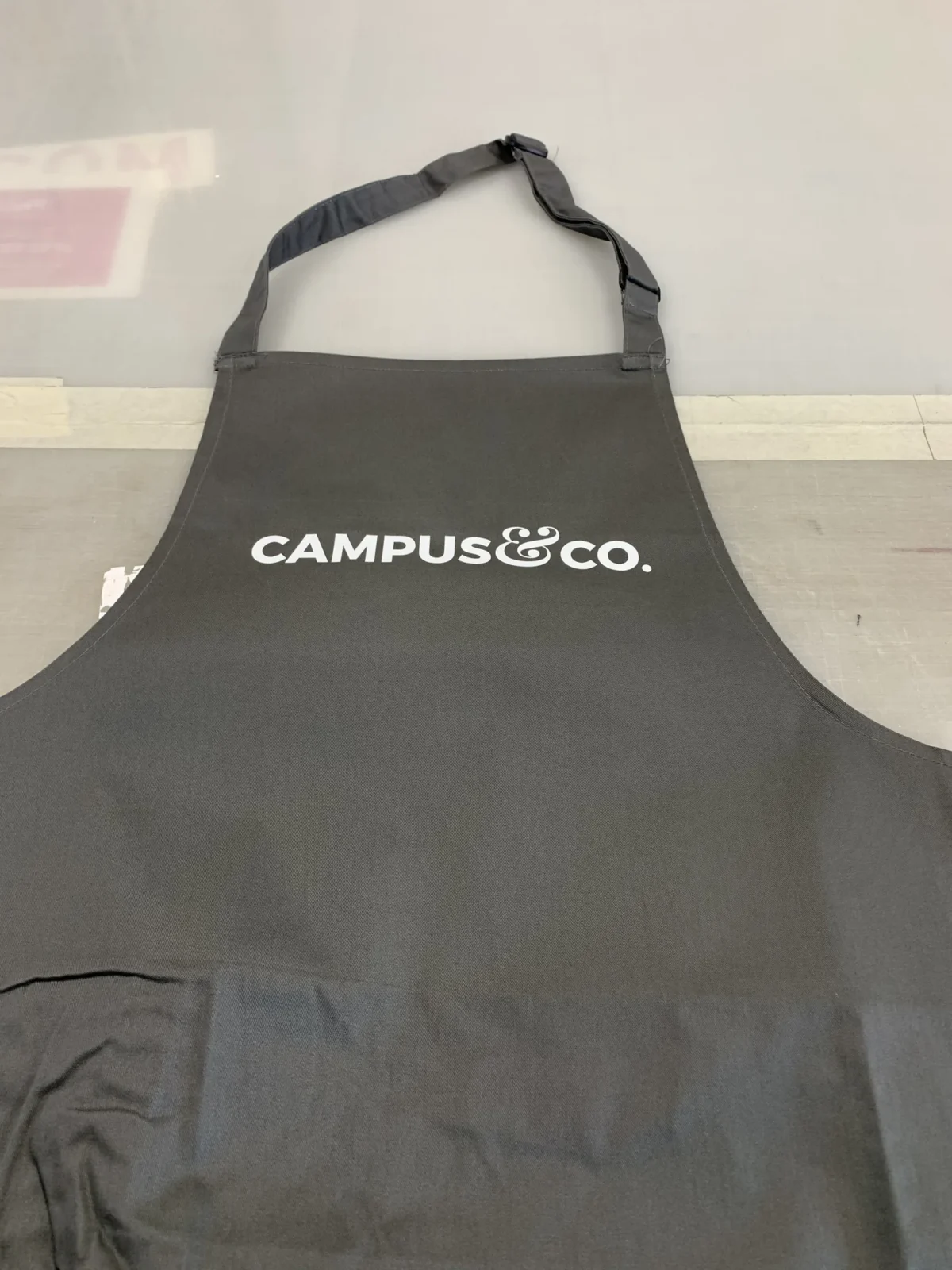 Black Campus & Co. apron with adjustable neck strap
