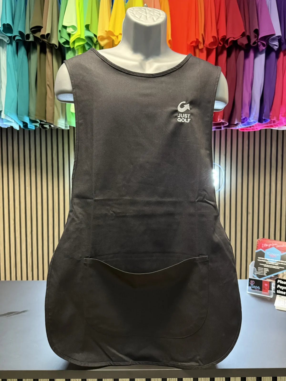 Black Just Golf apron displayed on mannequin
