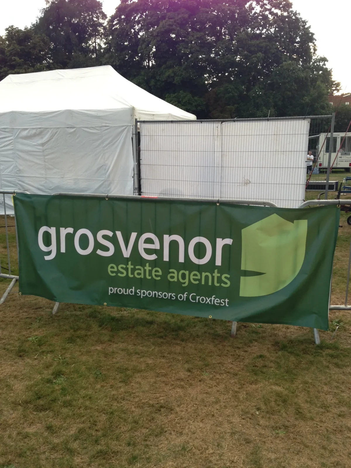 Grosvenor Estate Agents sponsor banner beside event tent