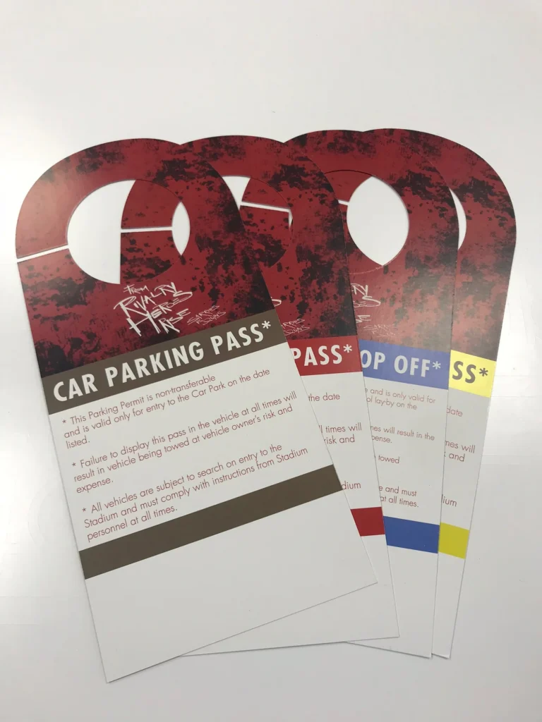 Four red stadium car parking passes with coloured labels