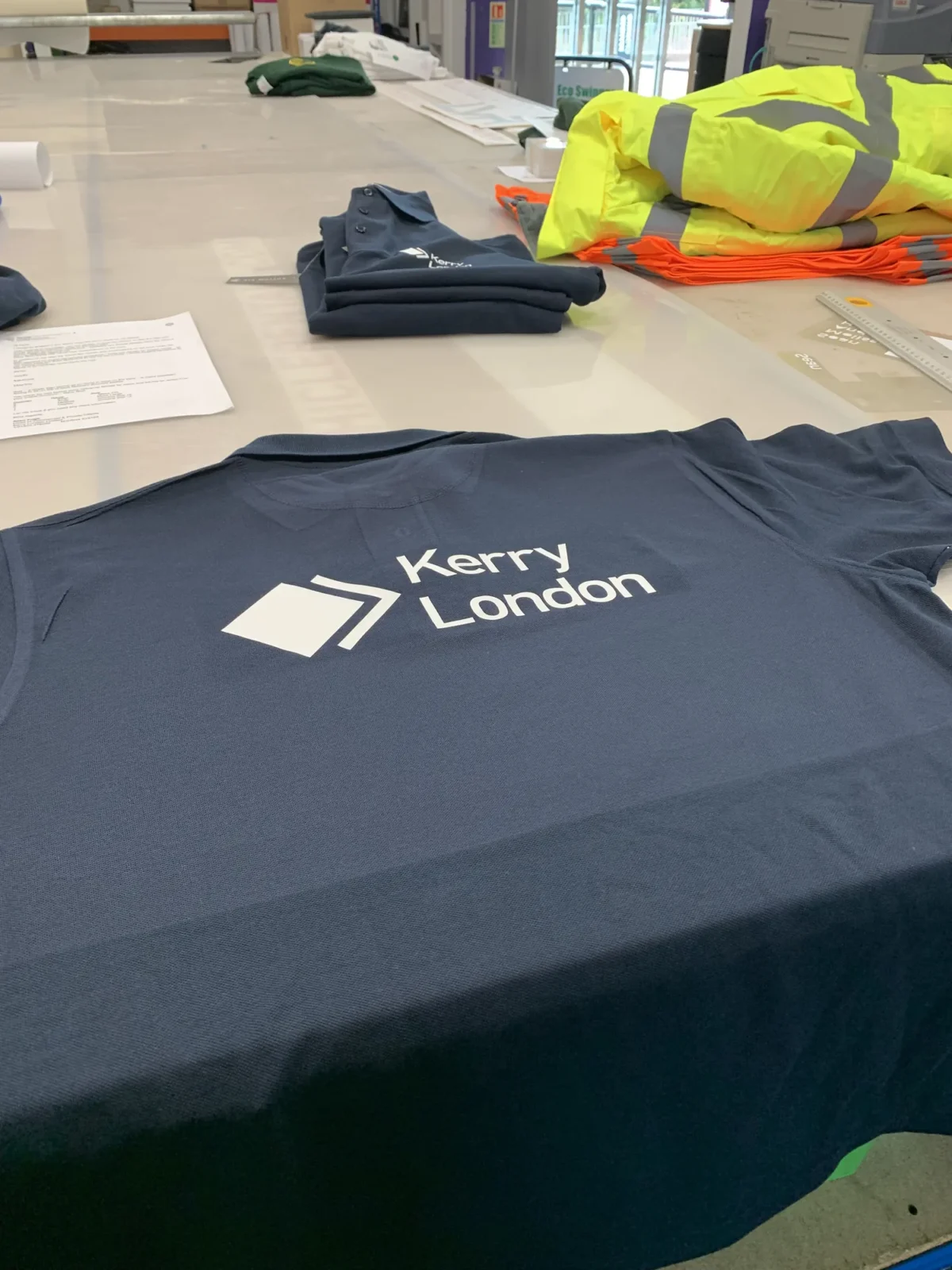 Kerry London branded polo shirt beside high-visibility workwear