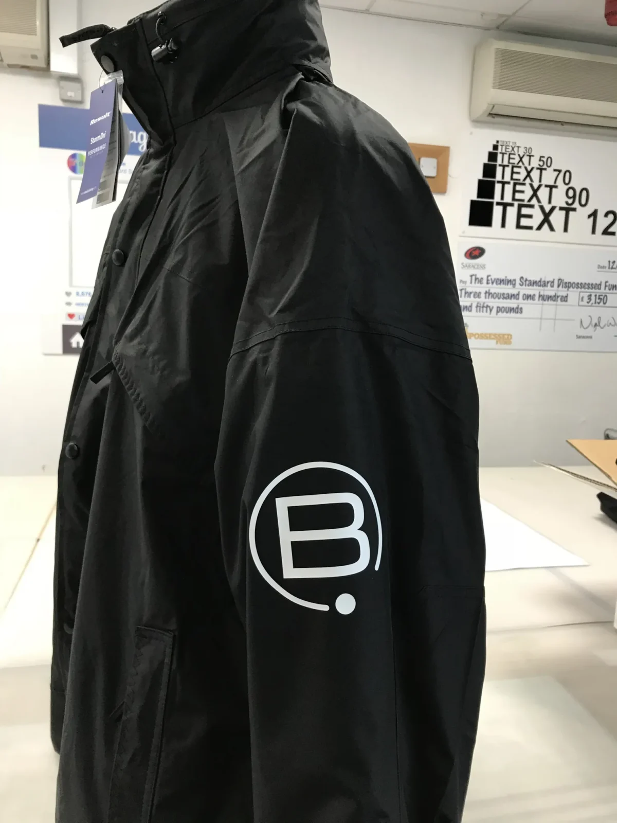 Black hooded jacket with white B logo on sleeve