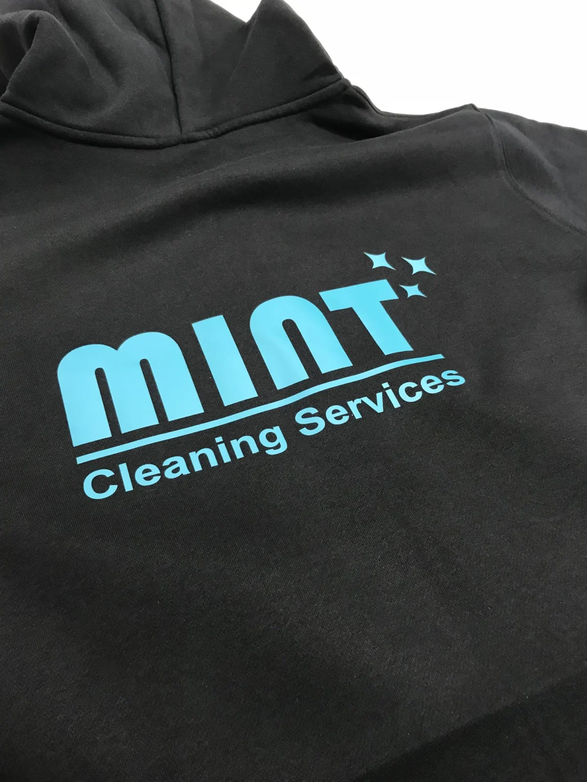 Black hoodie with Mint Cleaning Services logo