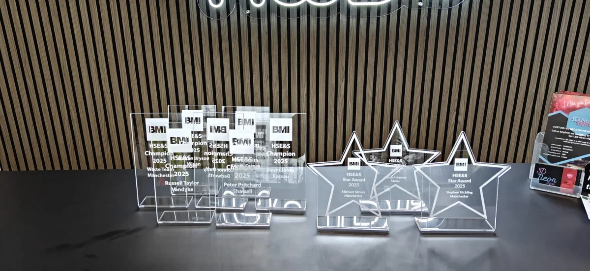 Clear acrylic BMI awards displayed on a black table