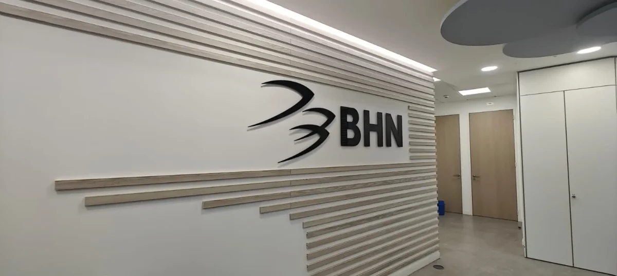 BHN logo displayed on a modern office reception wall
