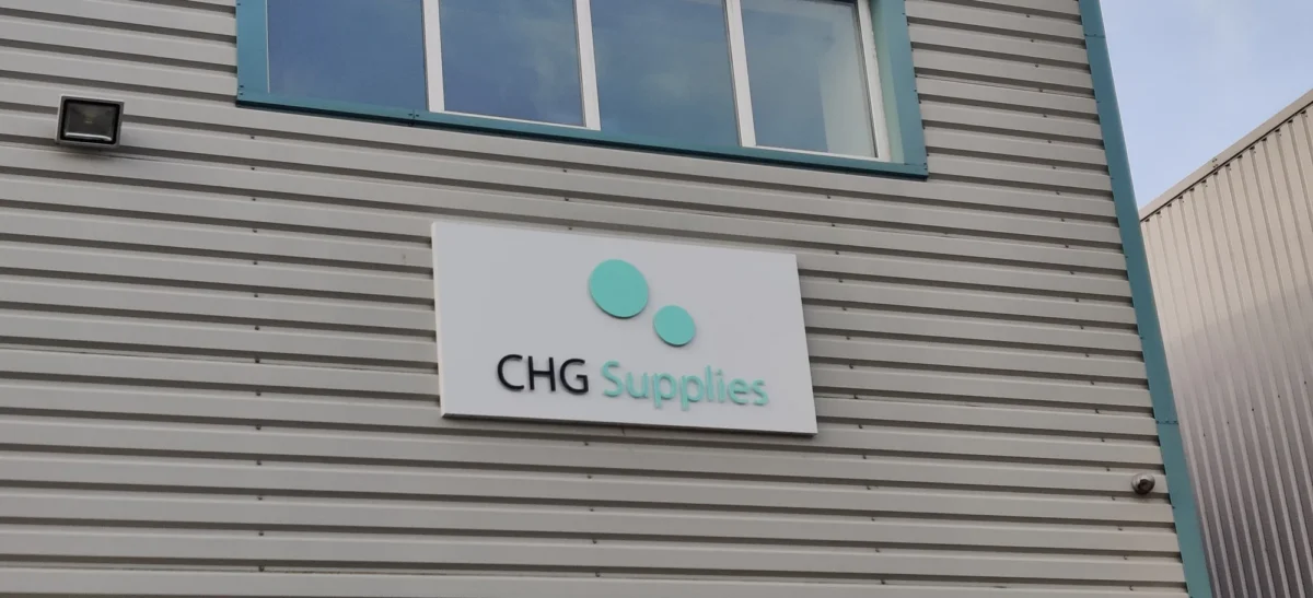 CHG Supplies sign on grey industrial building exterior