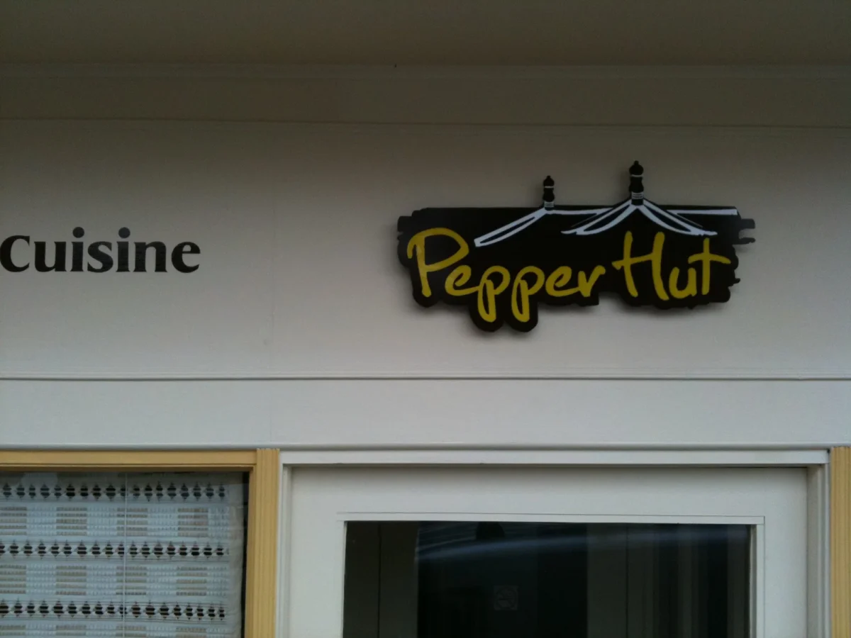 Cuisine Pepper Hut restaurant sign above entrance