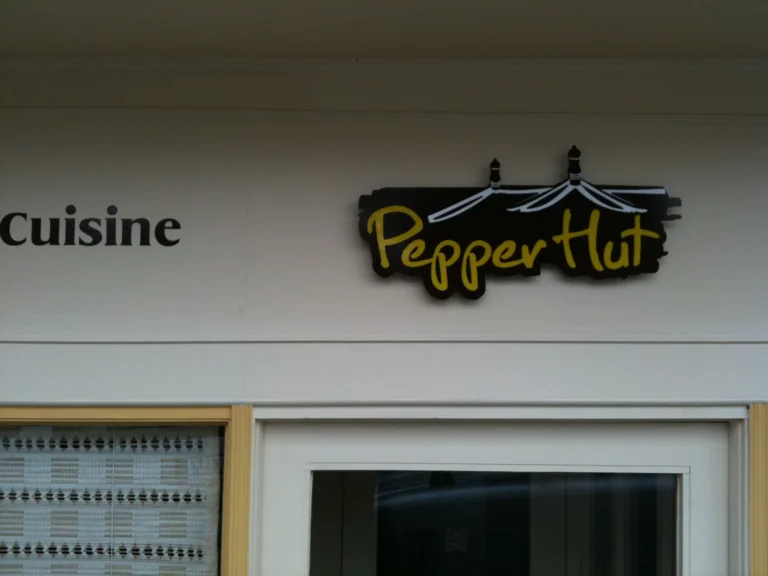 Cuisine Pepper Hut restaurant sign above entrance