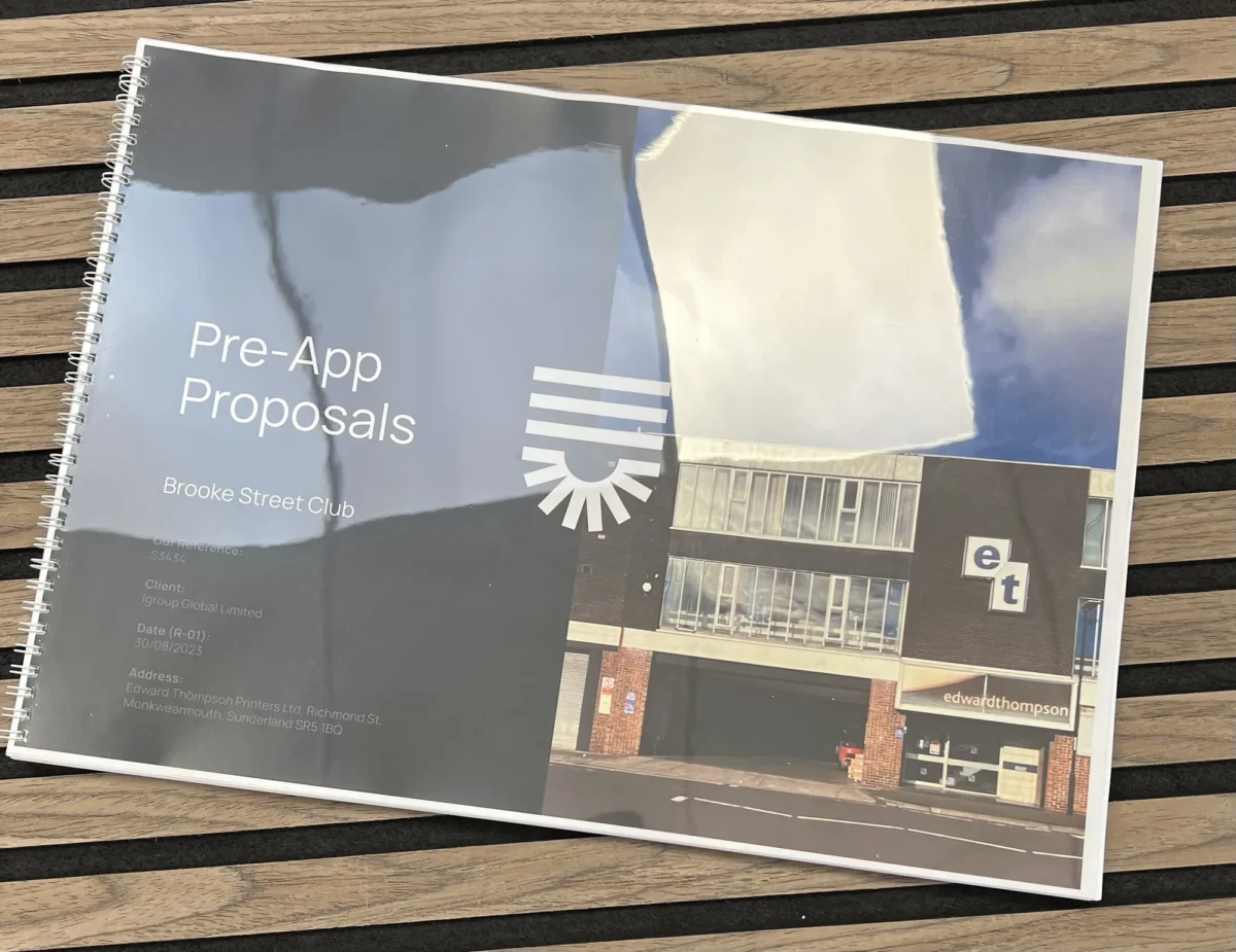Spiral-bound pre-app proposals booklet on a wooden bench