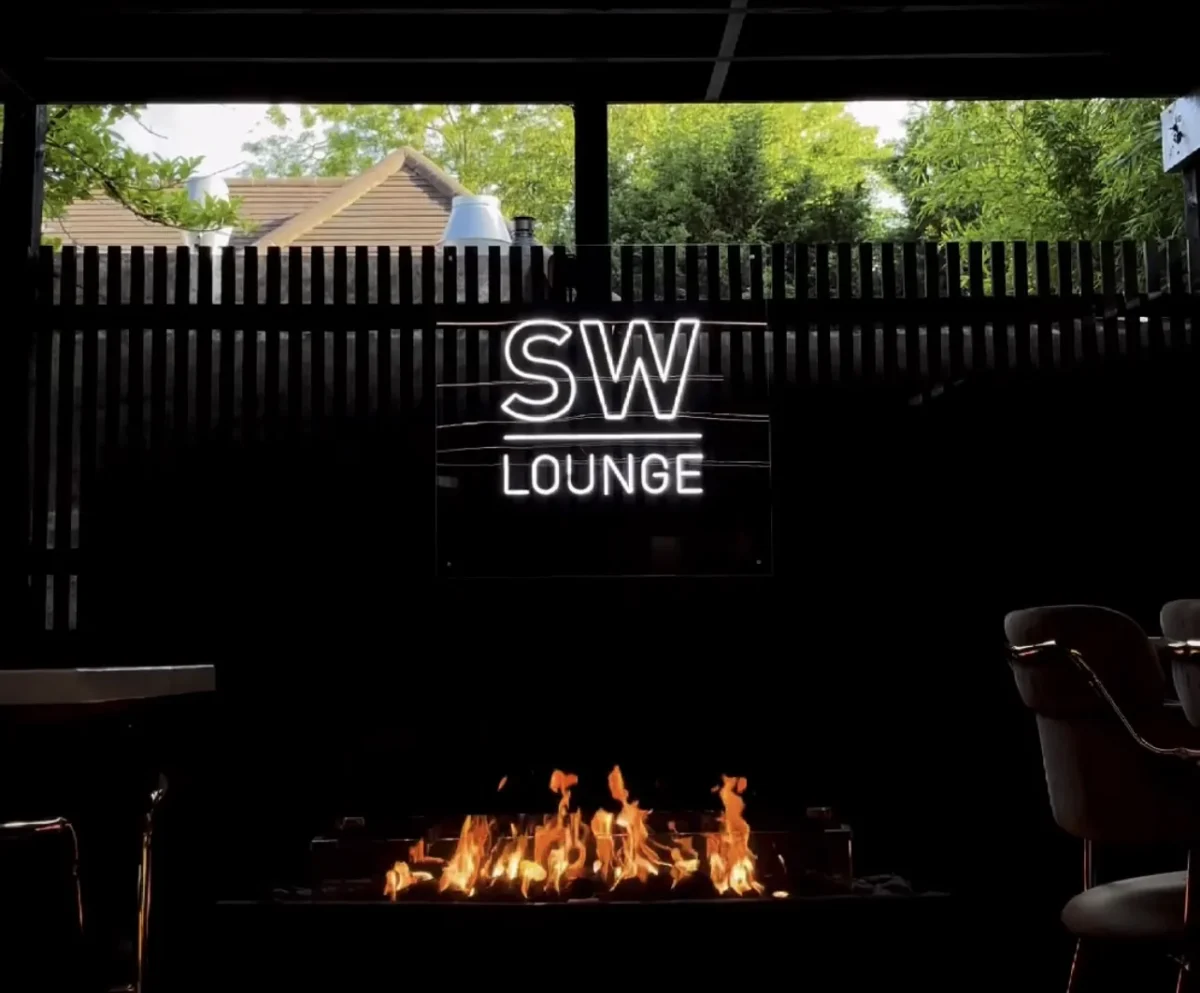 SW Lounge sign above an indoor fireplace