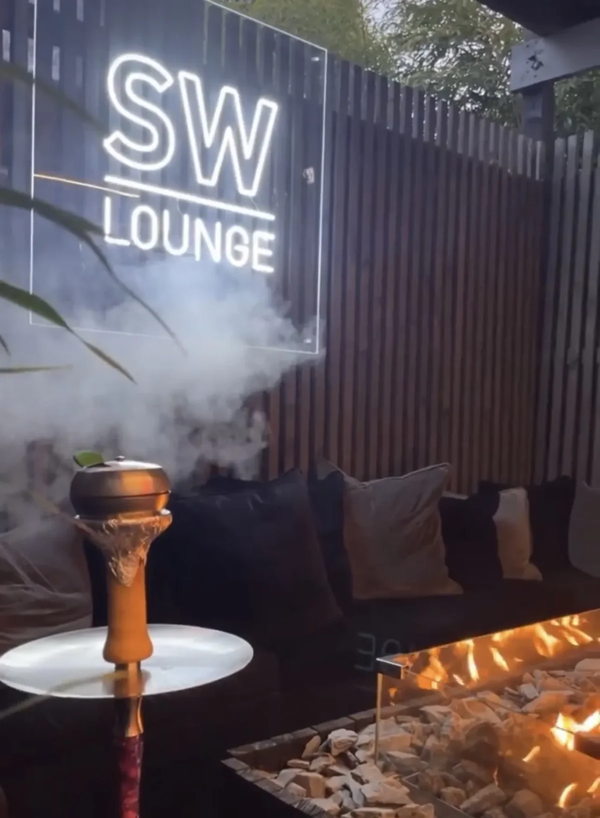 Smoking hookah beside fire in SW Lounge