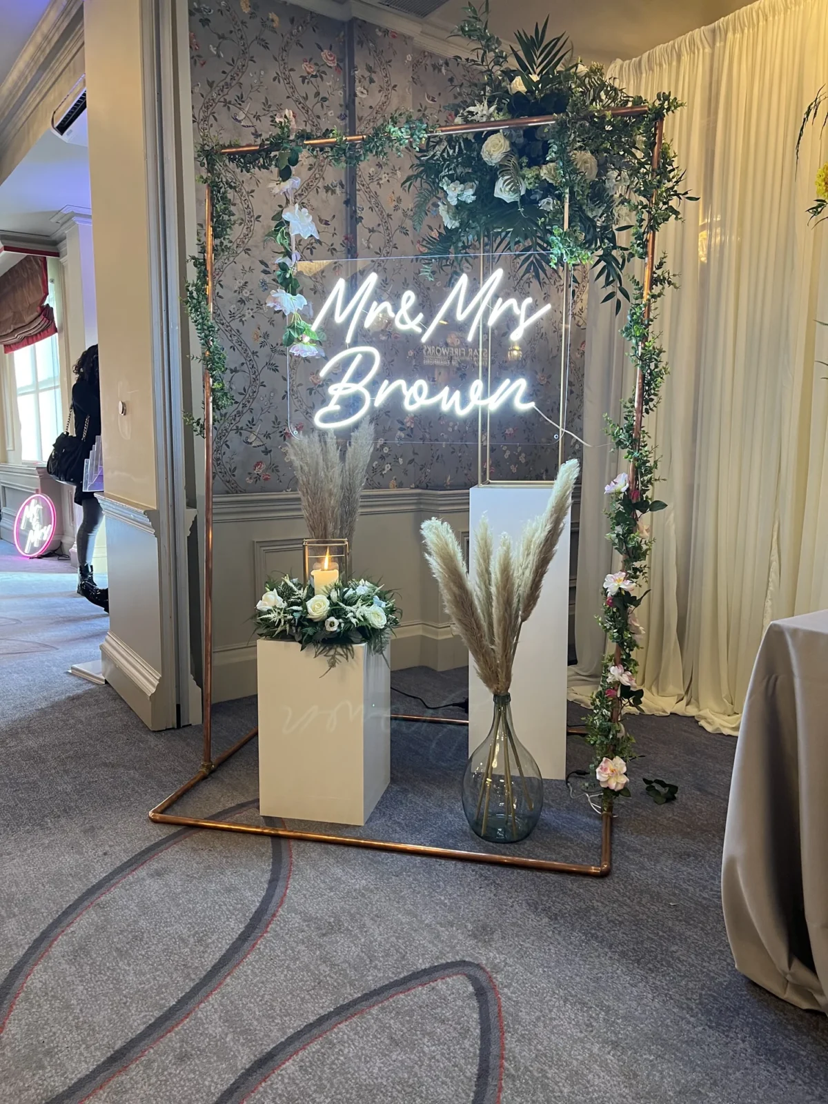 Floral wedding backdrop with neon Mr and Mrs Brown sign