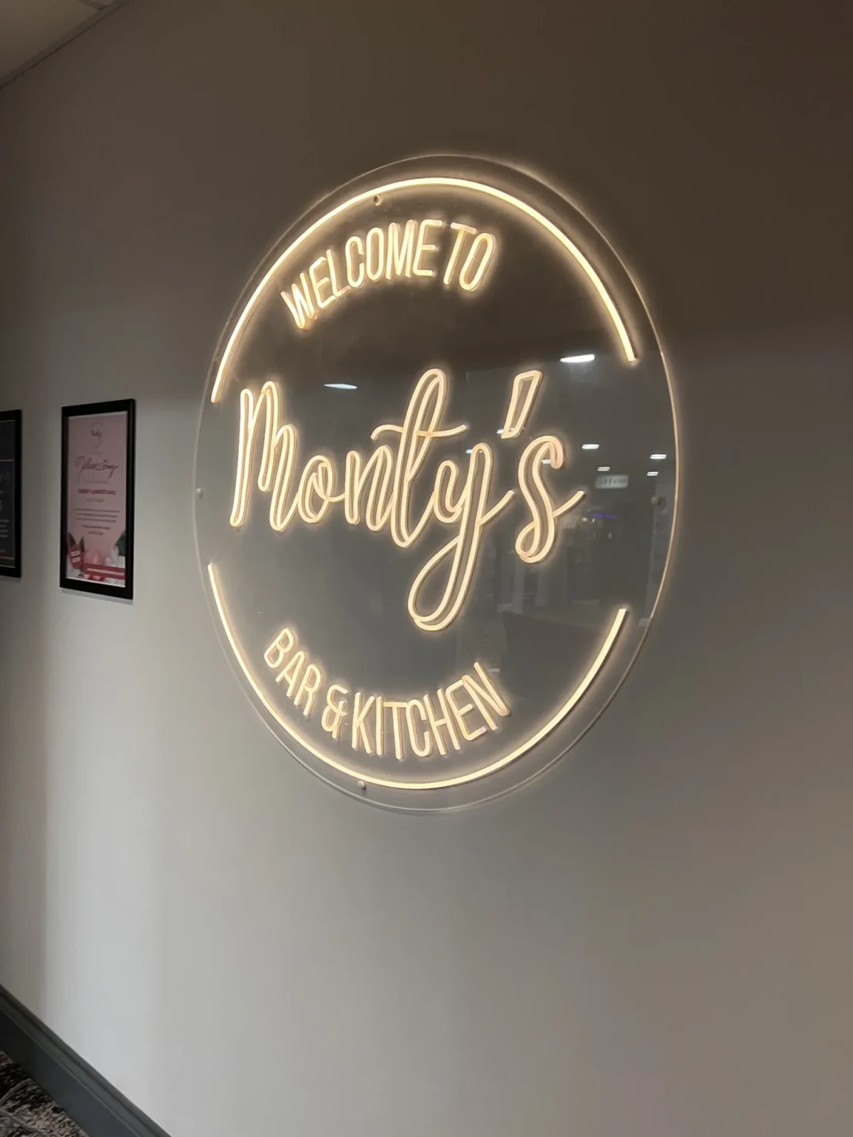 Illuminated Monfiya’s Bar and Kitchen welcome sign