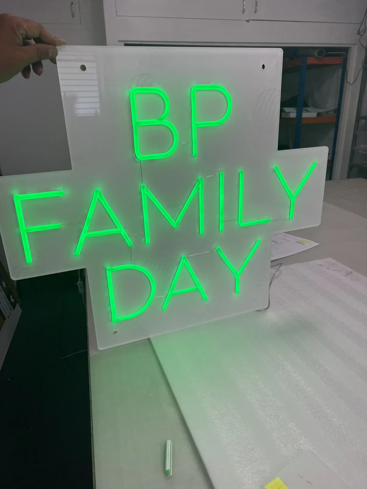 Green neon BP Family Day sign on acrylic panel