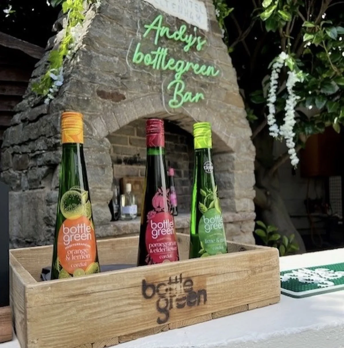 Bottle Green drinks displayed beneath Andy's Bottle Green Bar sign