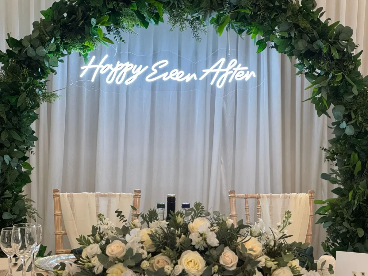Green floral arch with Happy Ever After neon sign
