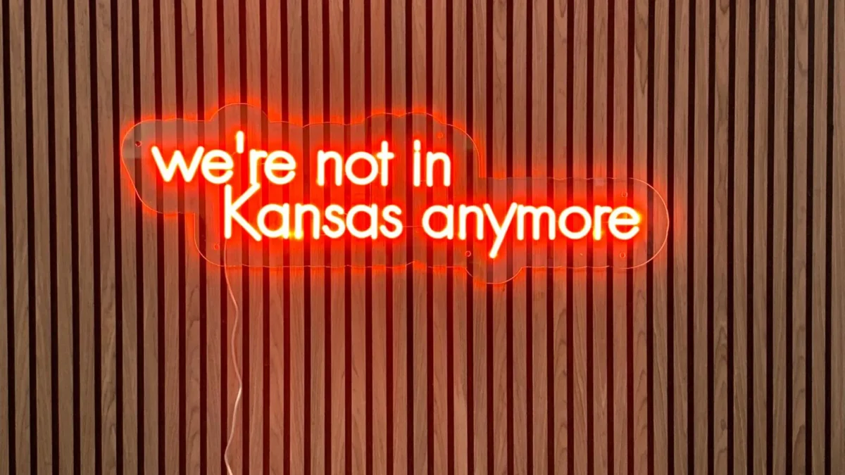 Red neon sign reads “we’re not in Kansas anymore”