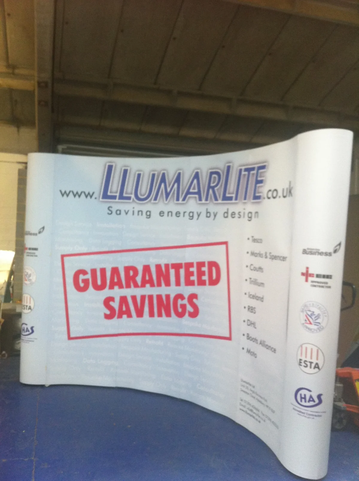 LumarLite exhibition banner promoting guaranteed energy savings