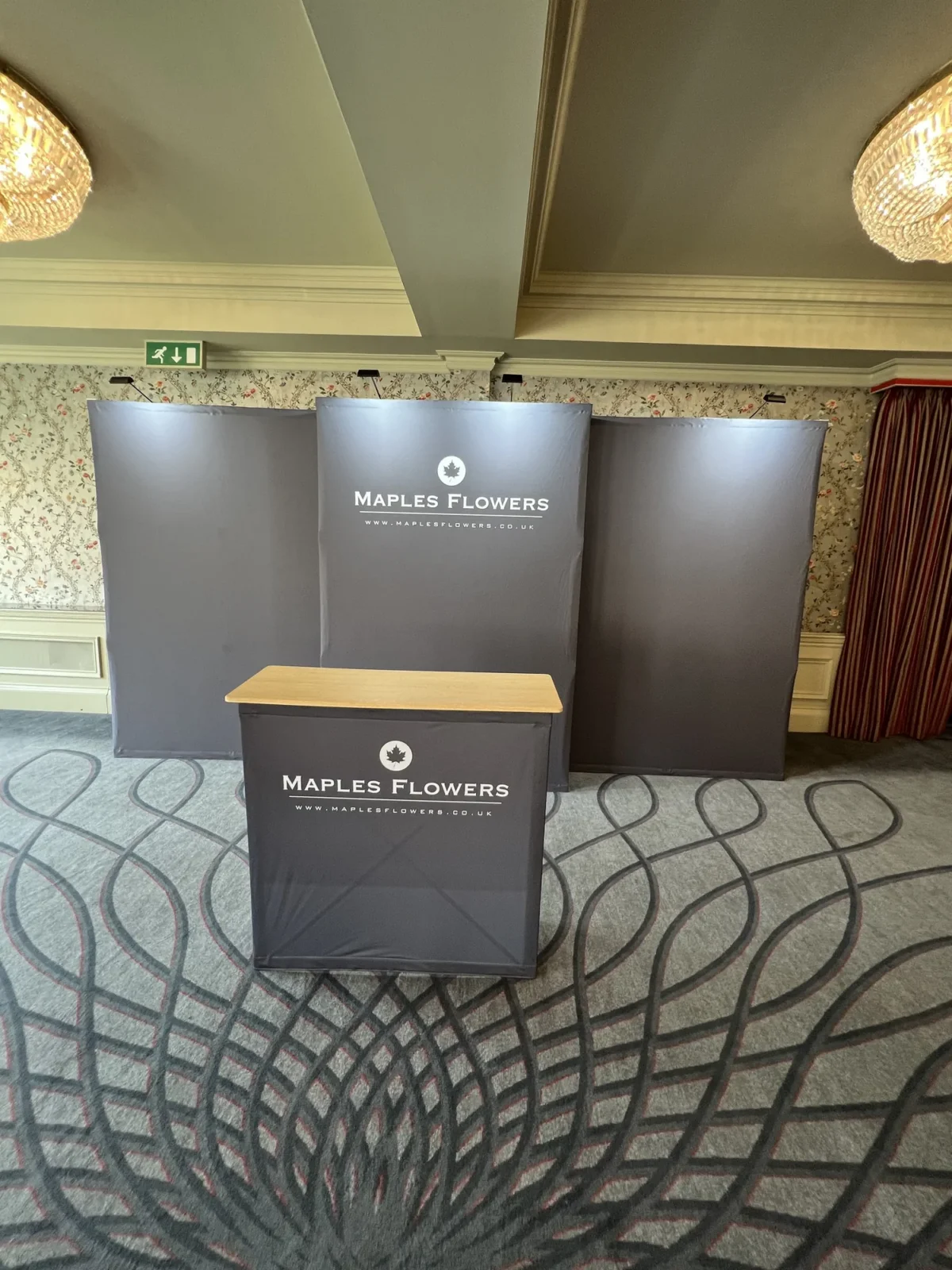 Maples Flowers branded display stands in a hotel function room