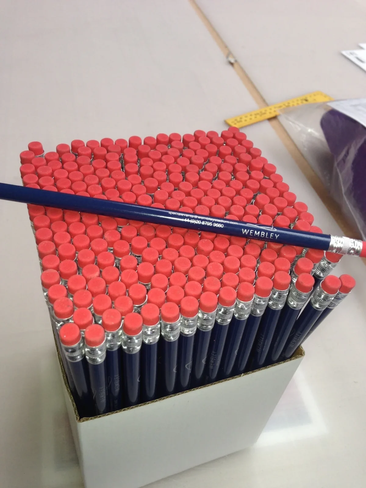 Box of navy Wembley pencils with red erasers