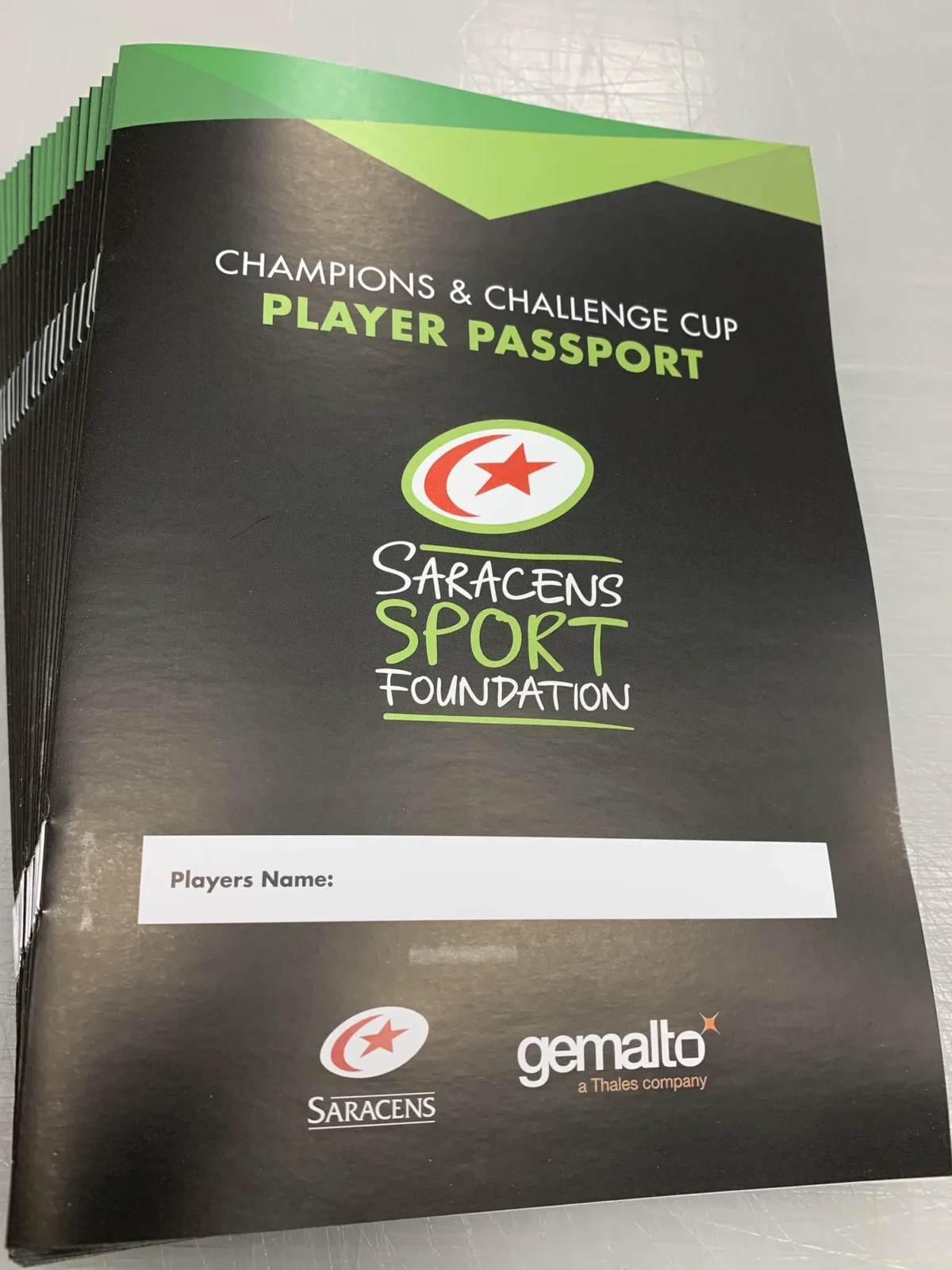 Stack of Saracens Sport Foundation player passport brochure
