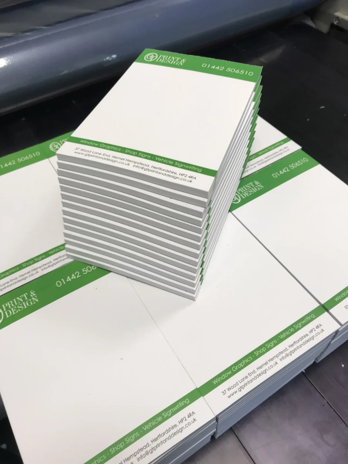 Stack of branded printed compliment slips