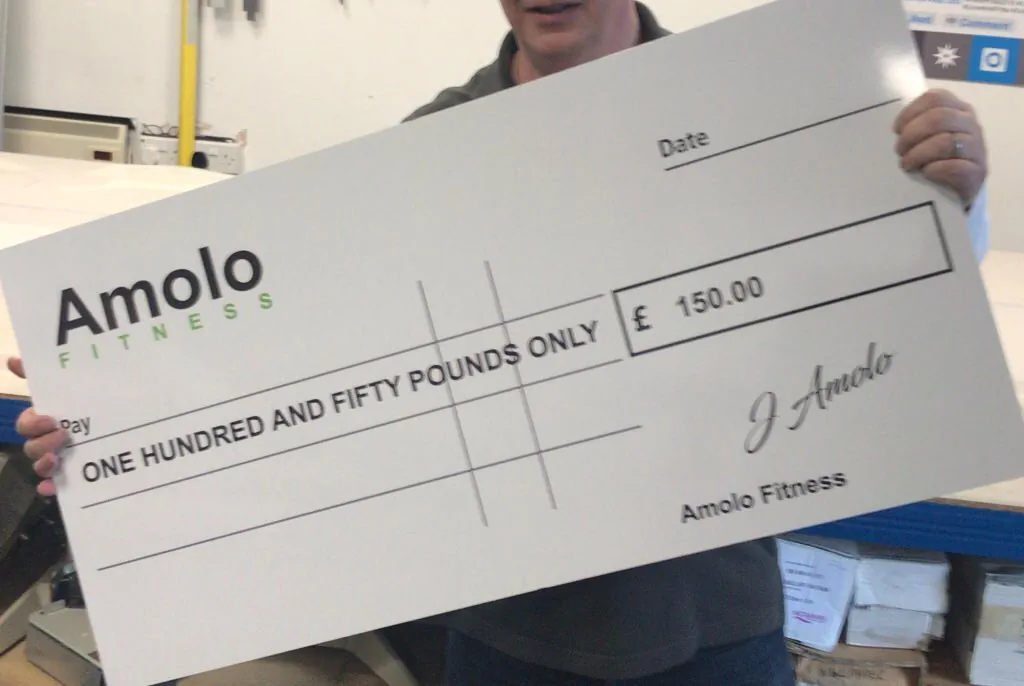 Person holding Amolo Fitness cheque for £150