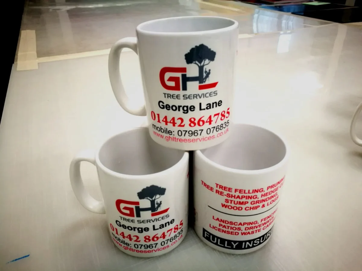 Three branded GHL Tree Services ceramic mugs