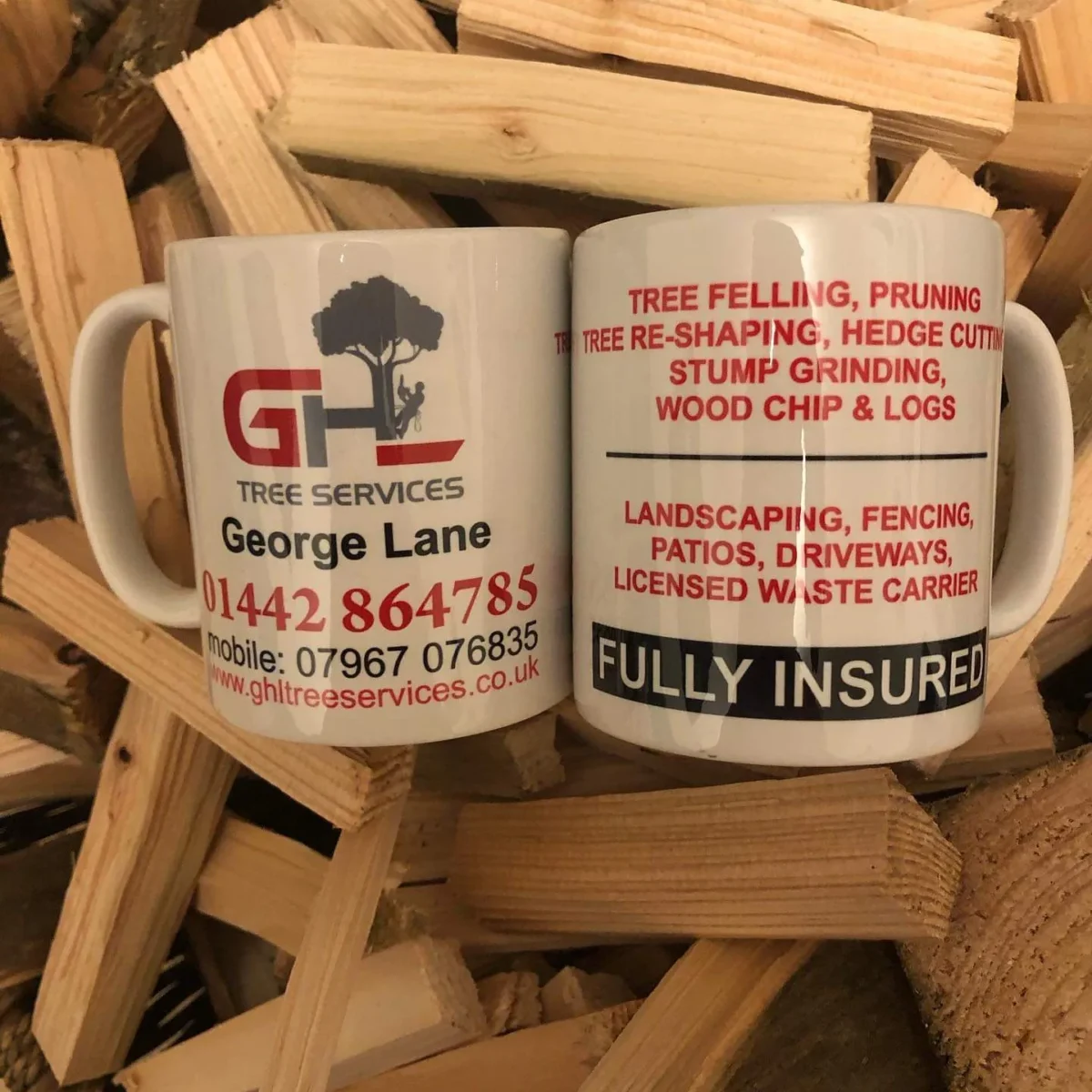 GHL Tree Services mug displayed among chopped firewood