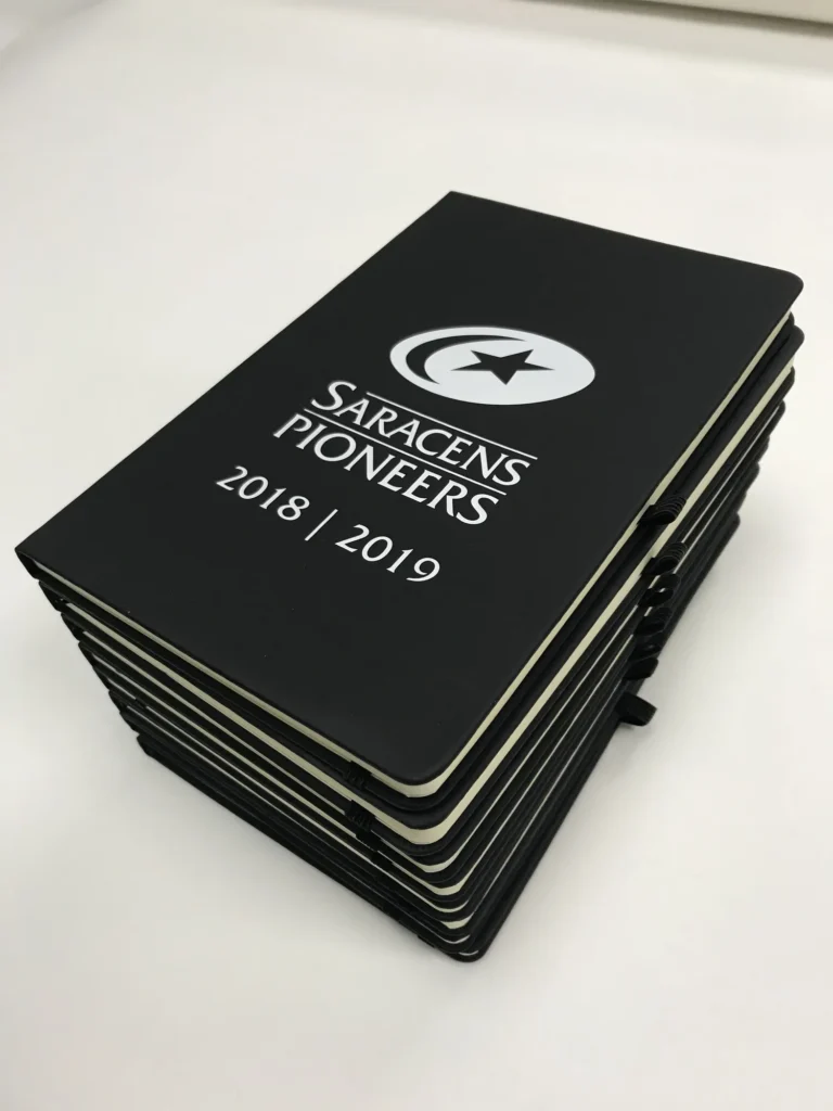 Stack of Saracens Pioneers notebooks