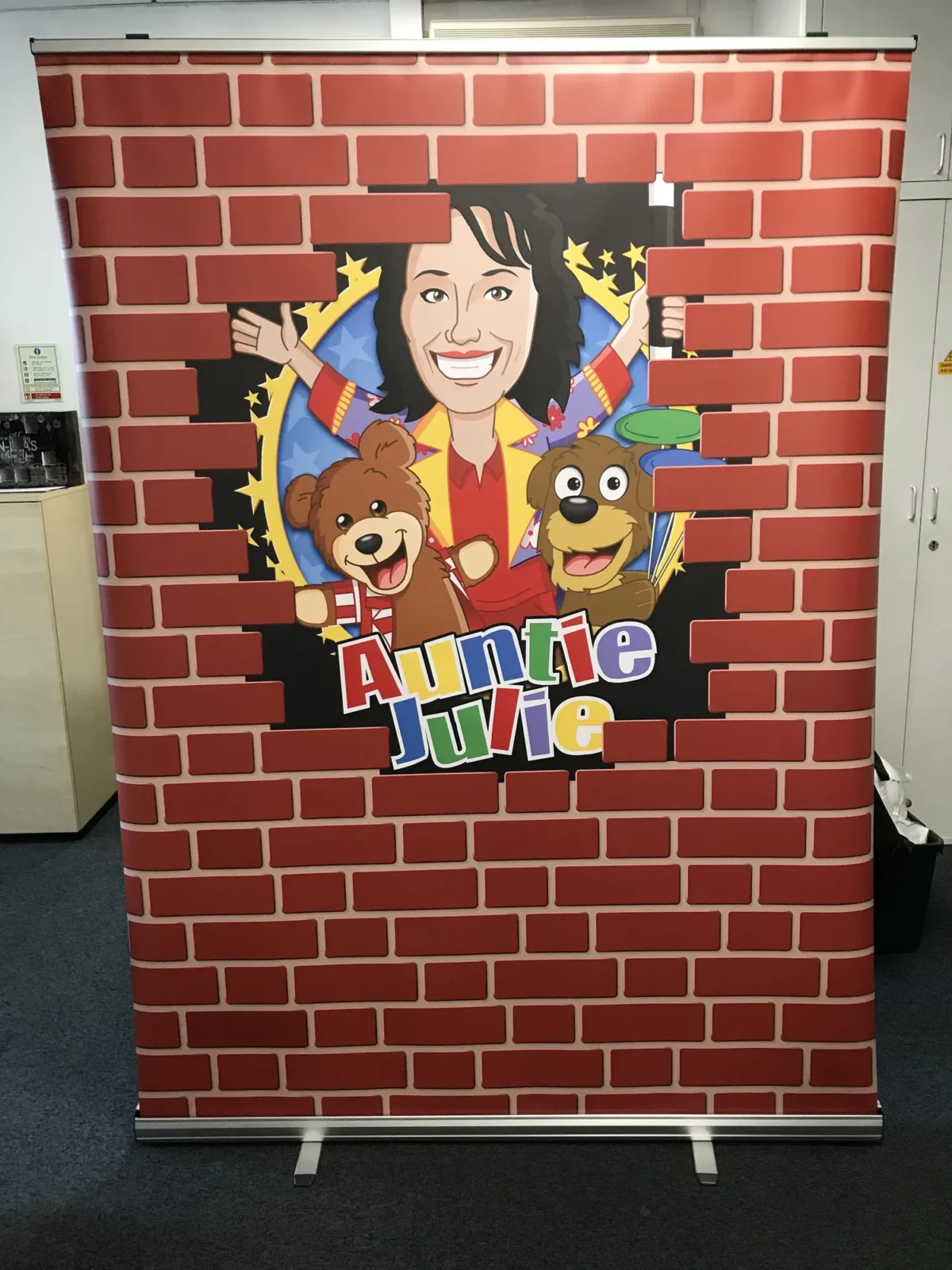Auntie Julie cartoon banner with bears behind a brick wall