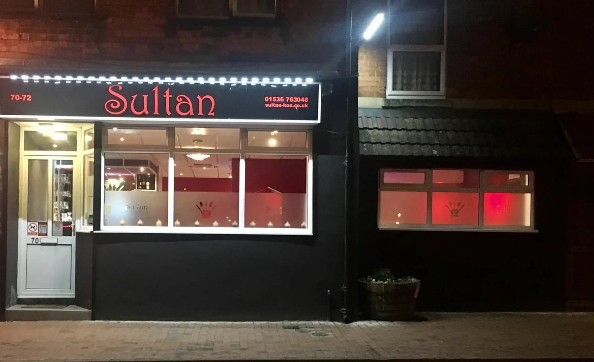 Sultan restaurant frontage illuminated at night