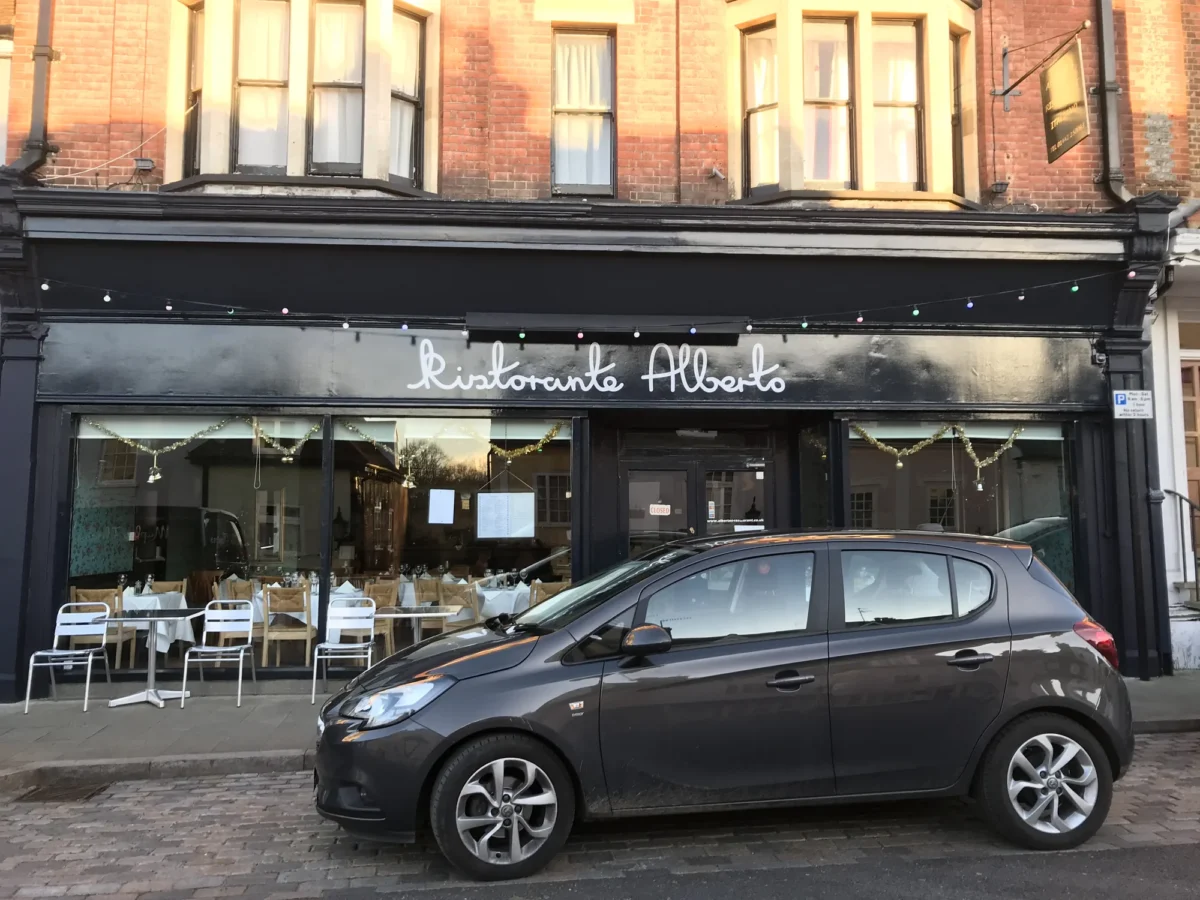 Parked car outside Ristorante Alberto restaurant frontage