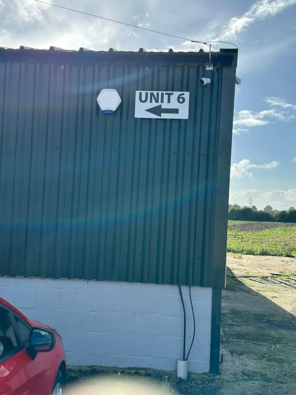 Unit 6 sign with left arrow on industrial building