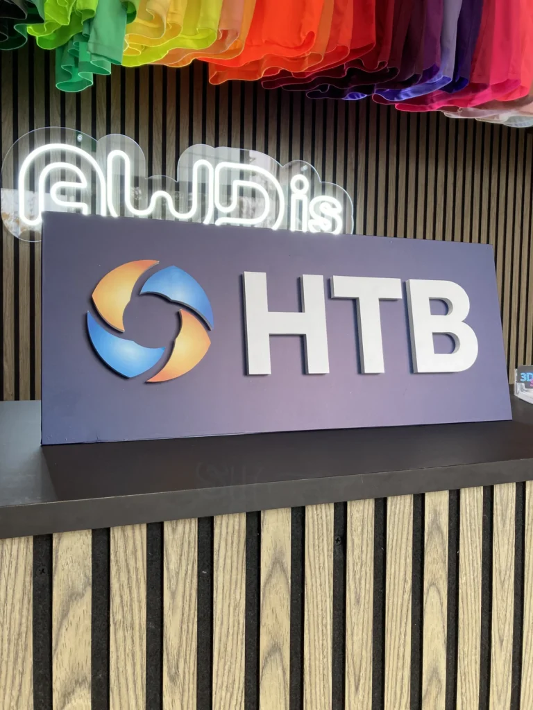 HTB reception sign beneath rainbow fabric decoration