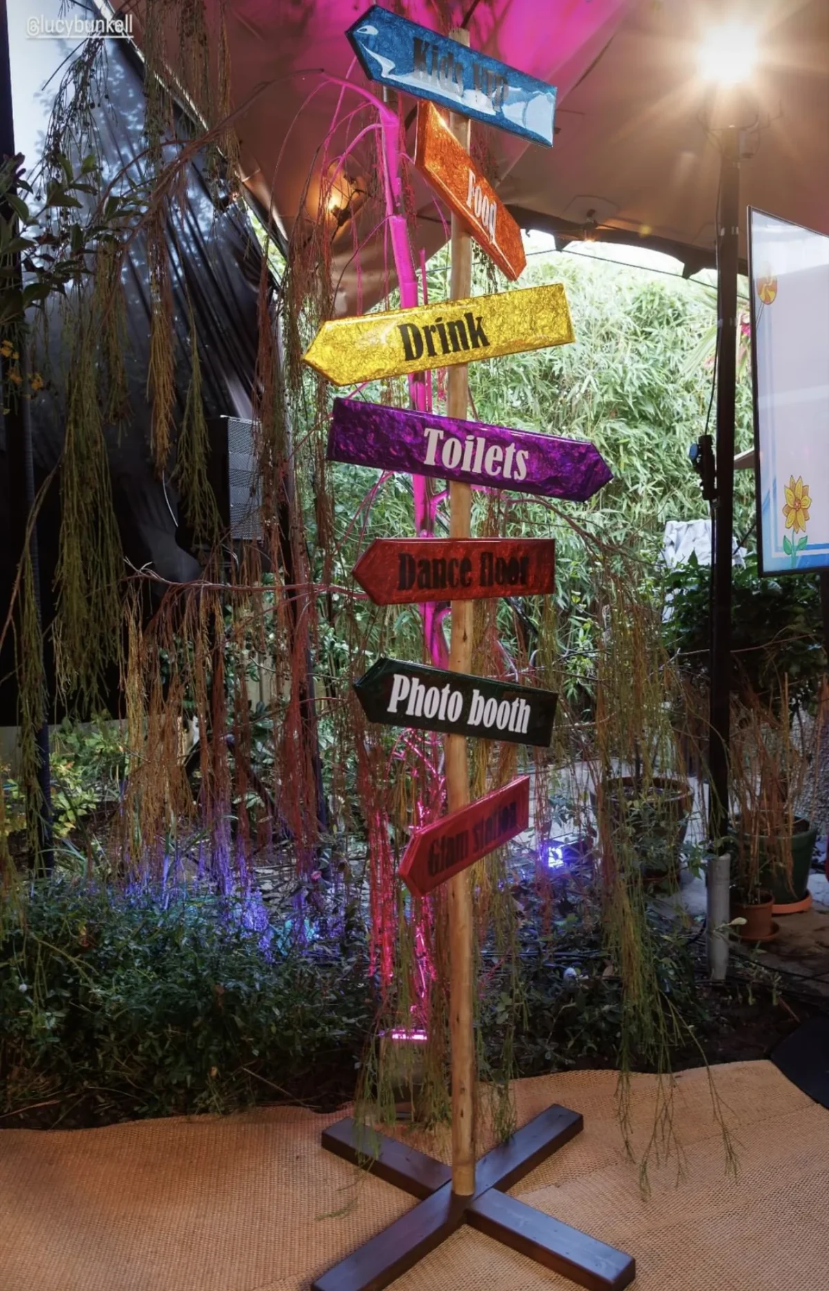 Colourful signpost directing guests to party amenities