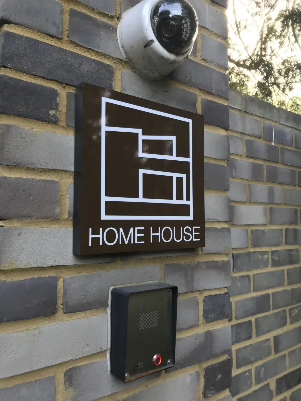 Home House entrance sign with CCTV camera and intercom
