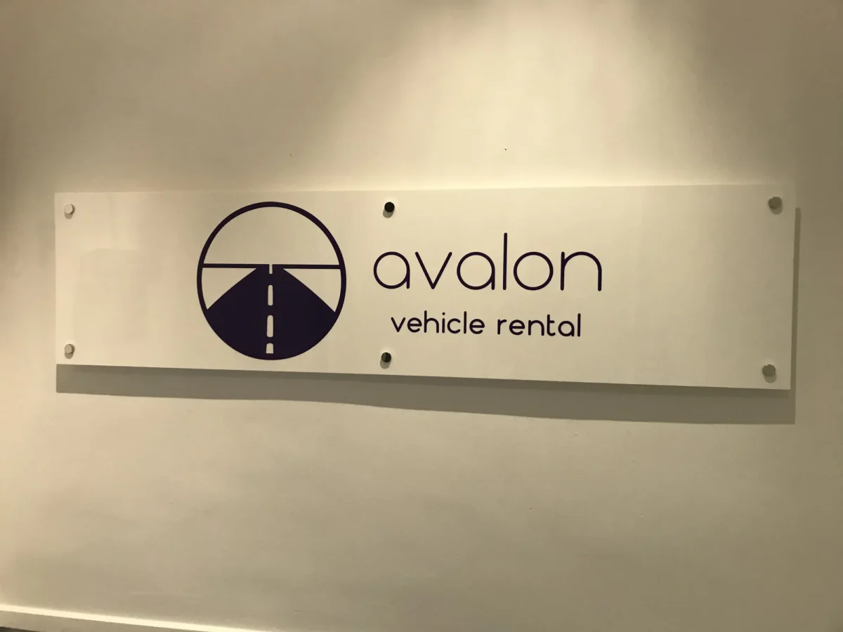Avalon vehicle rental sign with road logo