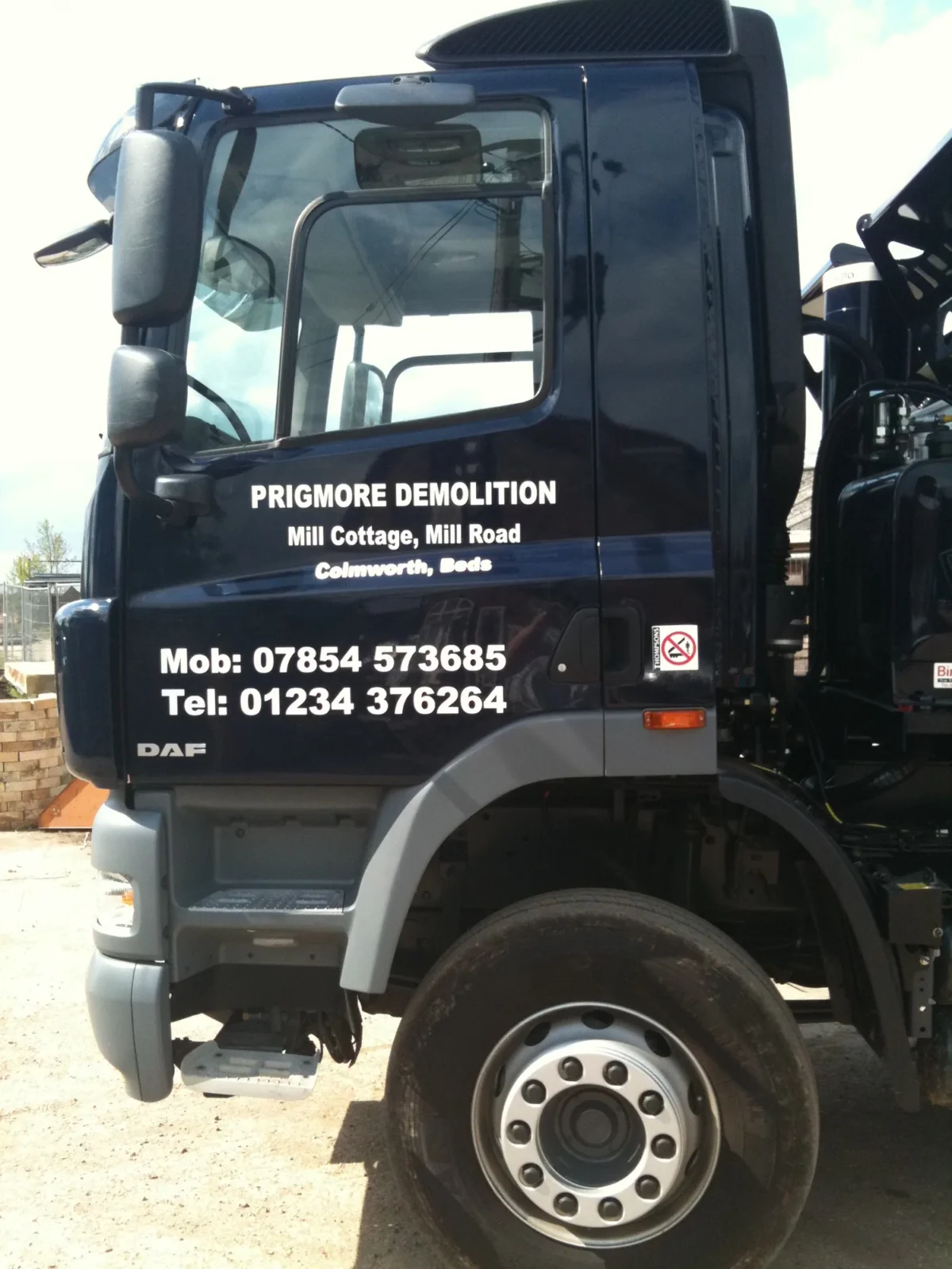 Prigmore Demolition lorry cab with company contact details