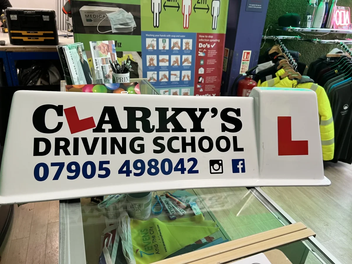 Clarky’s Driving School sign displaying learner driver L plate
