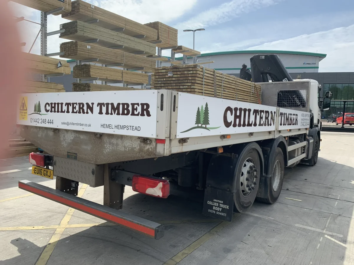 Chiltern Timber lorry loaded with timber beside storage racks