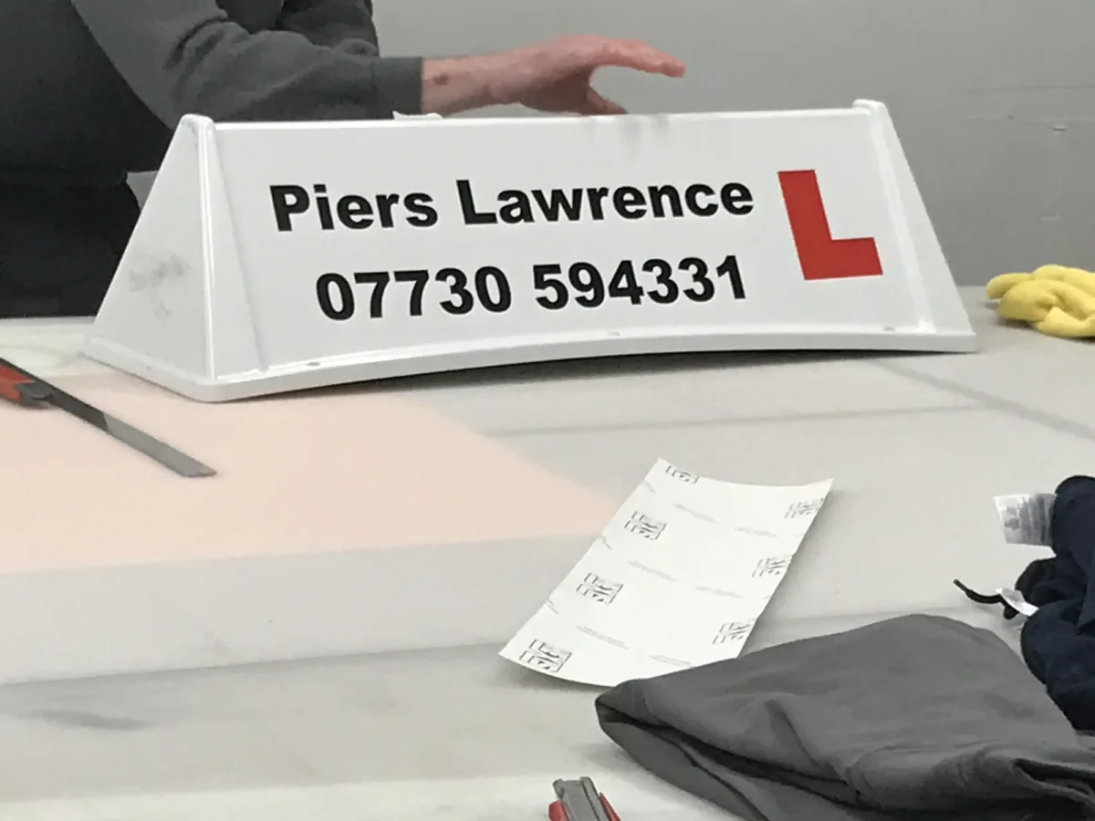 Piers Lawrence driving school sign with learner plate