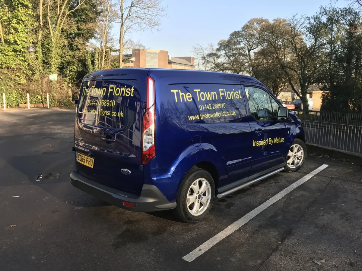 Blue Town Florist delivery van parked outdoors