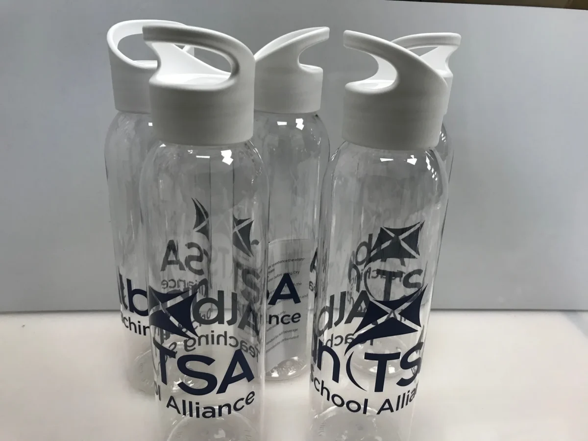 Four clear ISA-branded water bottles with white loop lids