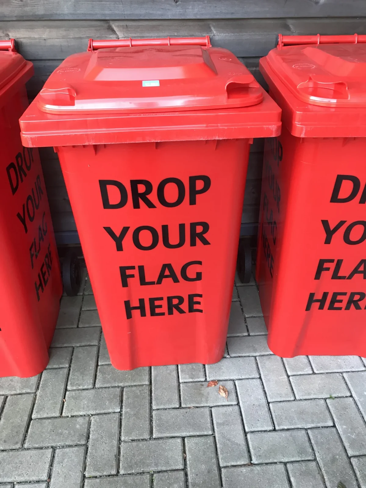 Red bins labelled “Drop Your Flag Here”